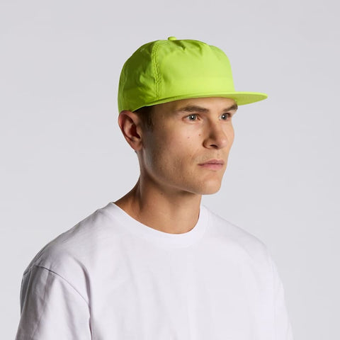 A bright neon yellow cap on a model, featuring a solid design and a logo on the side.
