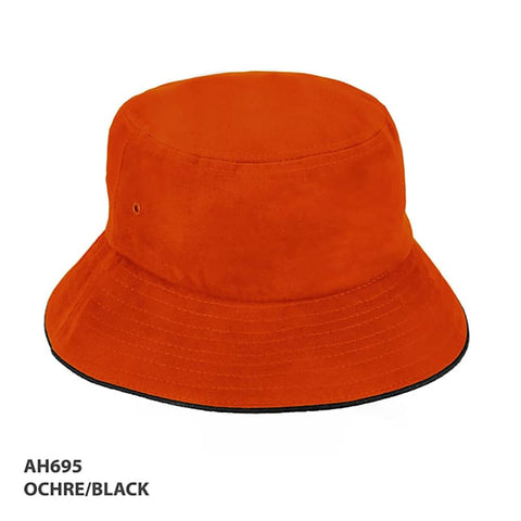An ochre and black HBC Sandwich Bucket Hat with a wide brim and a logo.